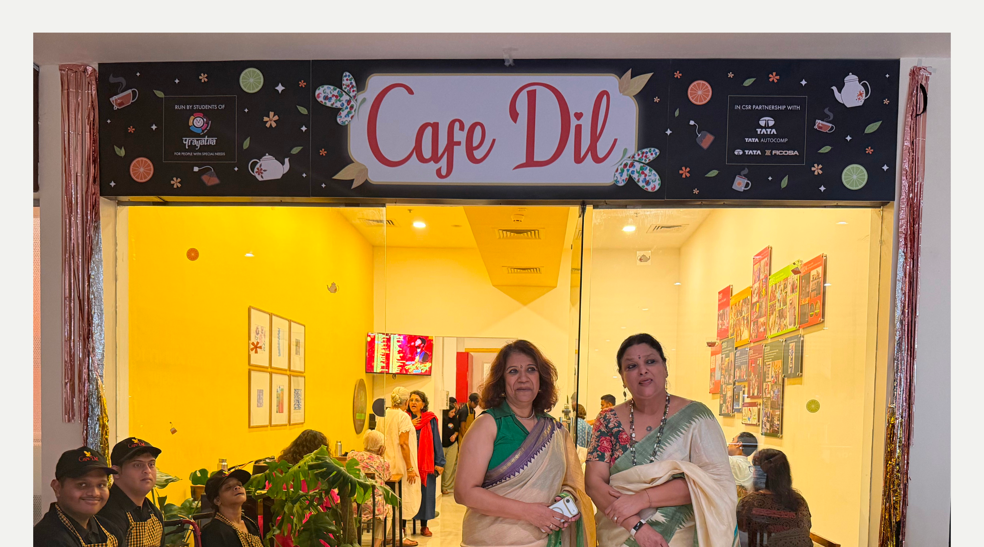 The cafe frontage, with founder-trustees Mridula and Radiya